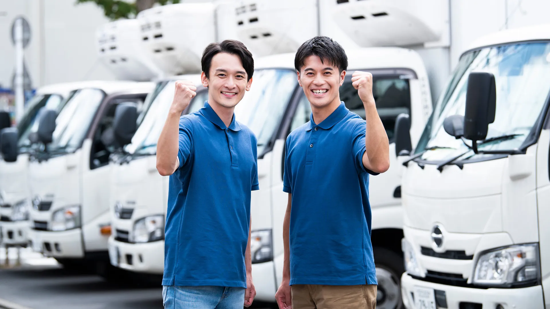 ガッツポーズをする男性トラックドライバー2人